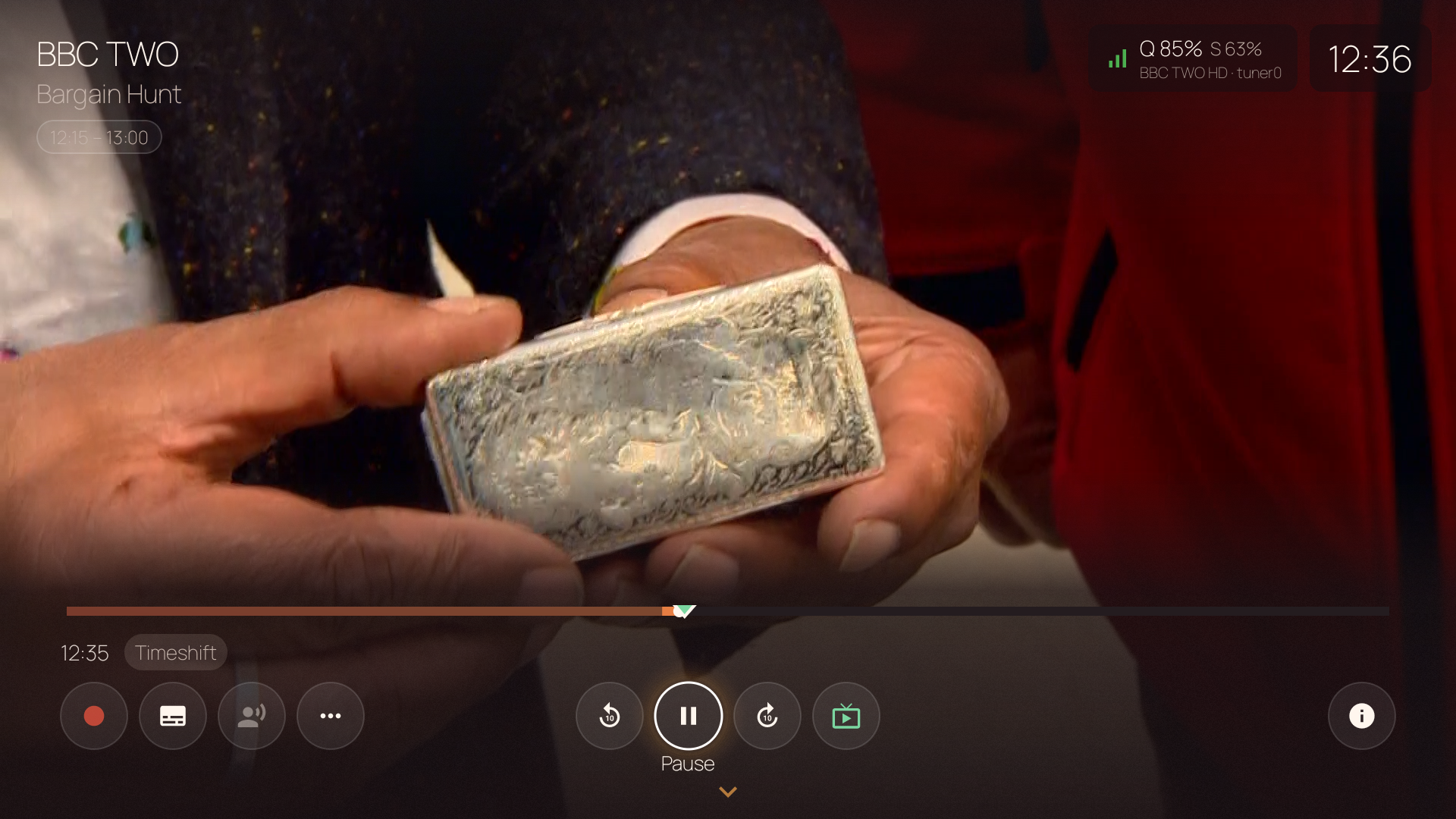 Player overlay in timeshift mode — "Timeshift" badge, seek bar with live edge marker